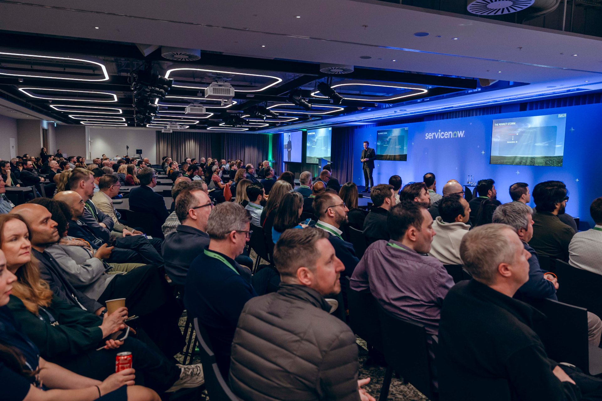 Danilo McGarry speaking on stage to an executive audience